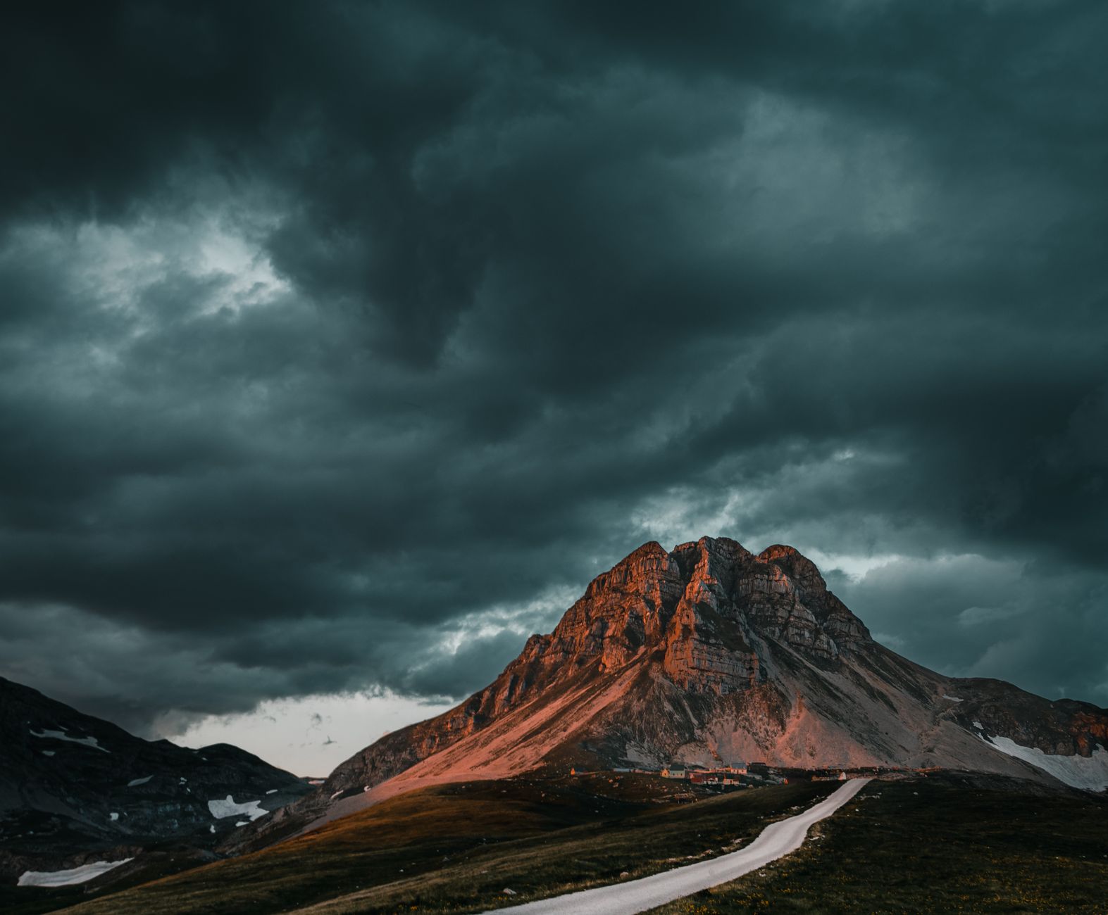 Panoramic view of mountain peaks and pristine winding roads